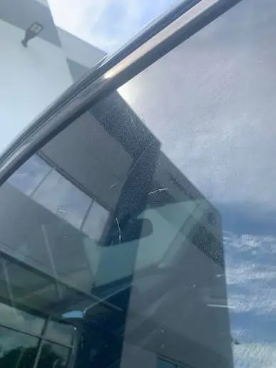 Deep scratch on a luxury glass window pane and aluminum profile